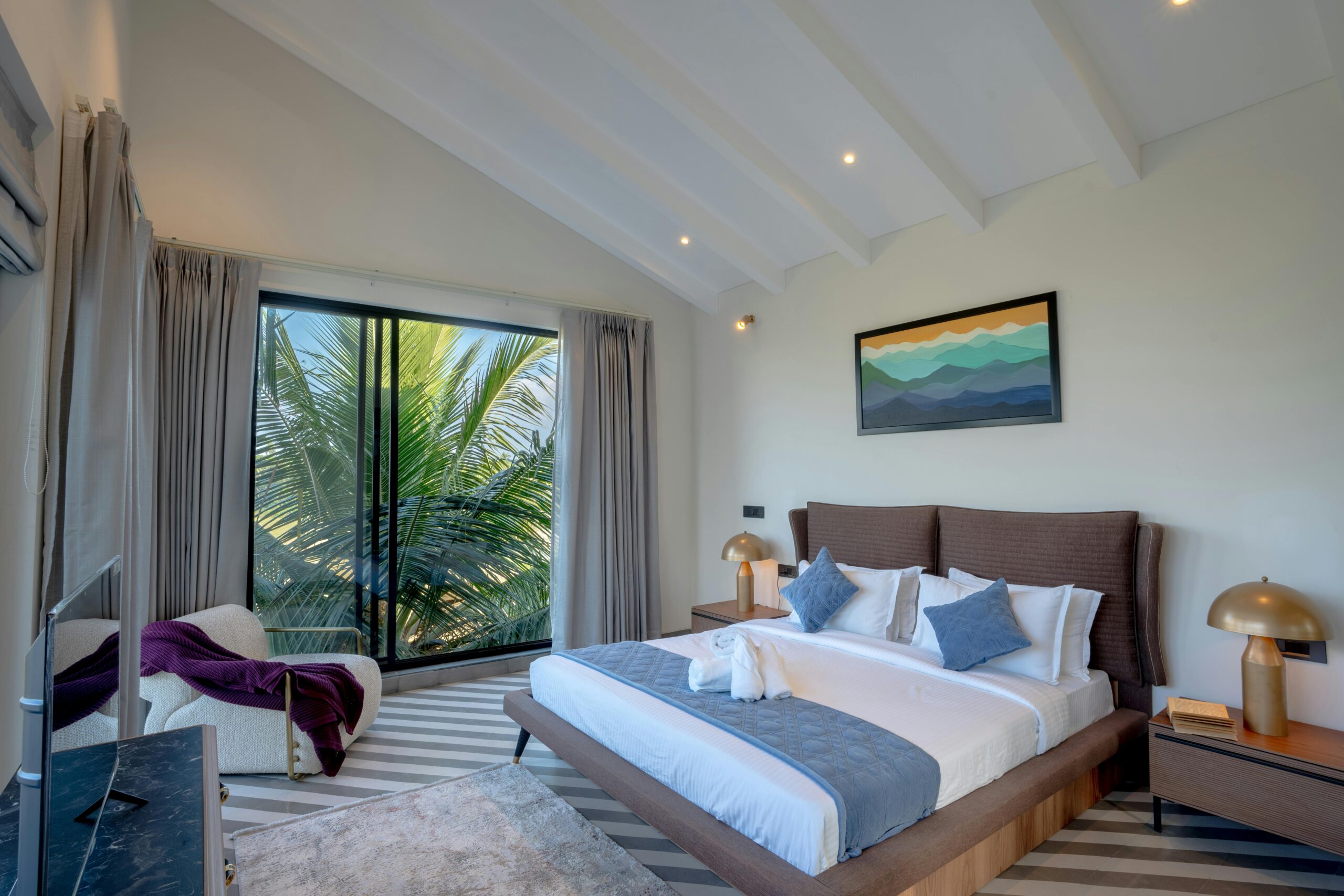 Elegant bedroom interior in a luxury villa in Saligao, Goa, India, featuring modern furnishings.