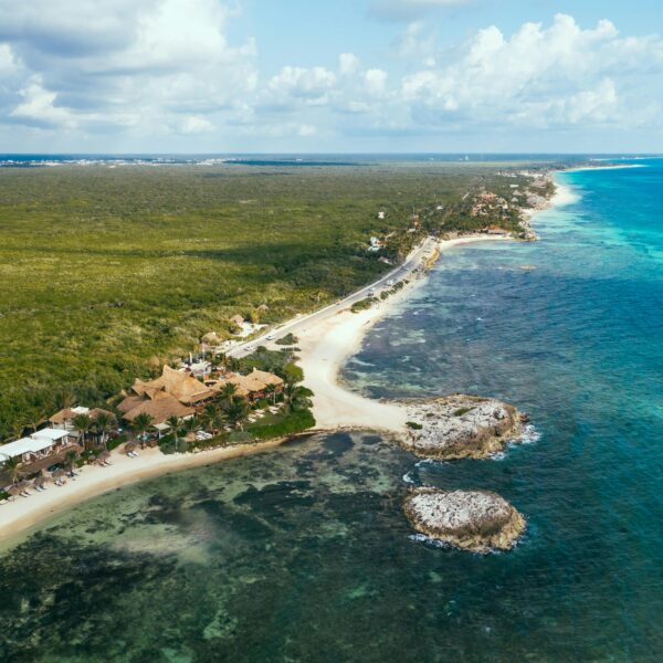 Stunning aerial view of the pristine coastline and lush greenery in the Riviera Maya, Mexico.